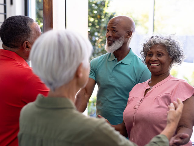 Senior couple visiting another senior couple