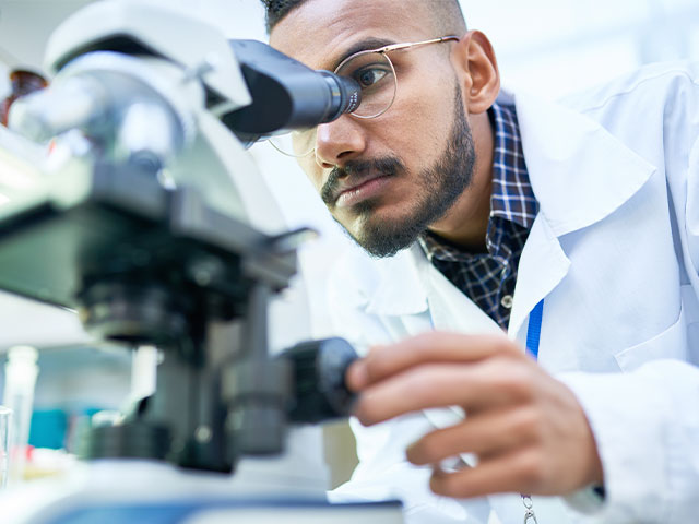 Entomologist looking into microscope